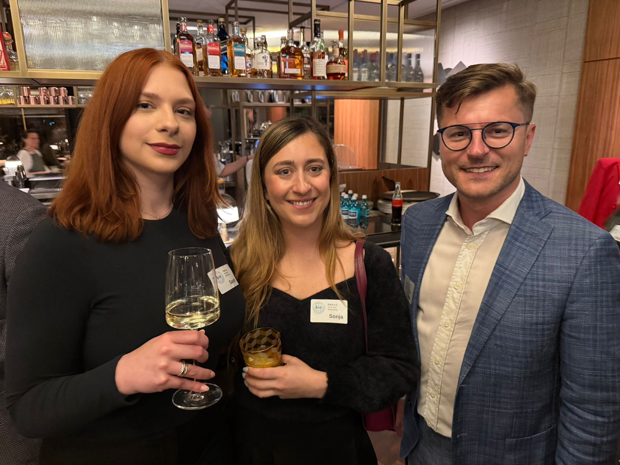 Two FIAA members in conversation at the bar